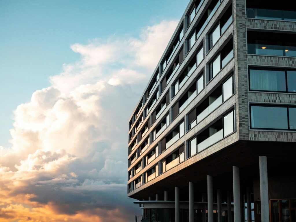 Contemporary multi-story building against a stunning sunset sky.